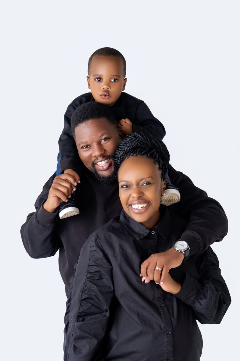 Father carrying his son on his shoulders beside the mother