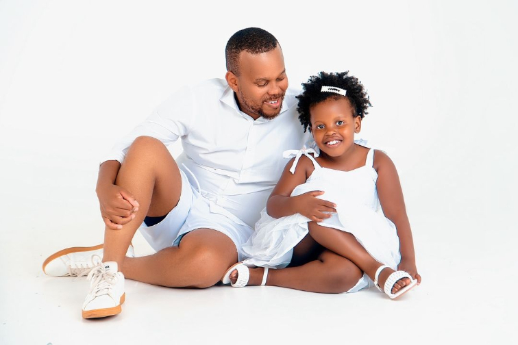 Father and daughter laughing during a family portrait