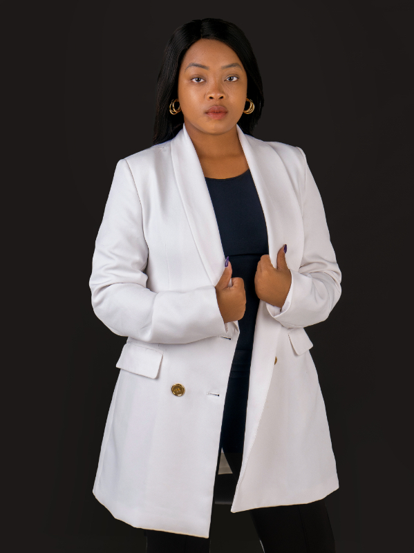 Business portrait in a white blazer on a black backdrop