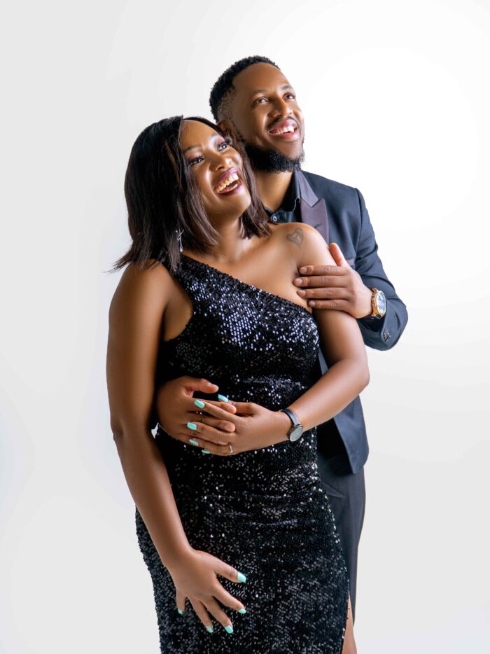 Couple embracing and laughing in a studio portrait