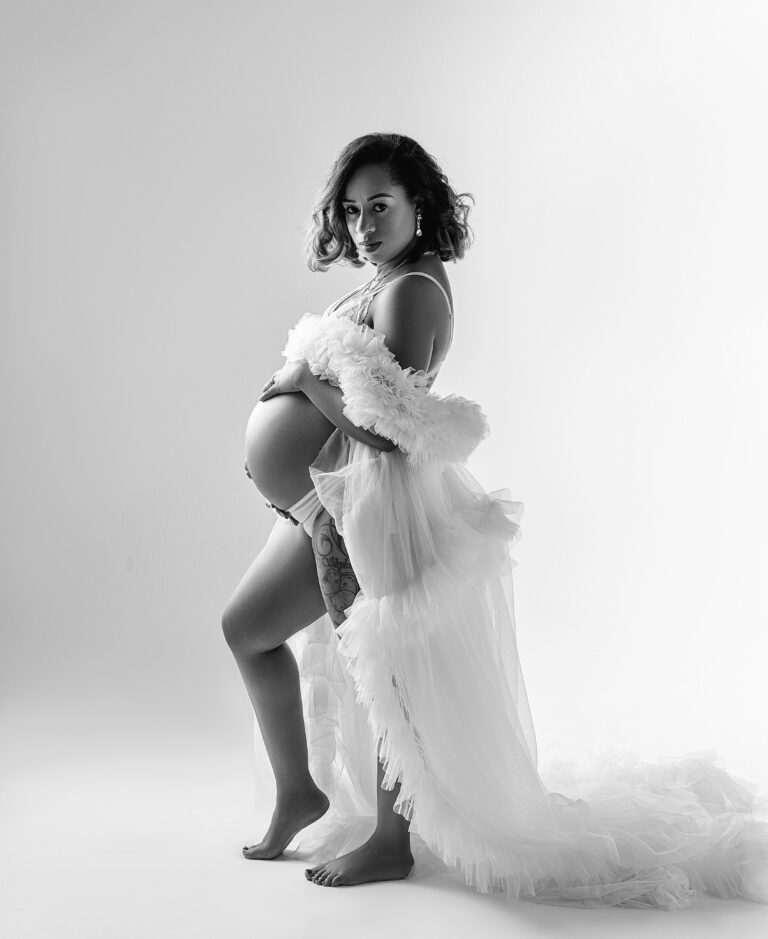 Black and white maternity portrait in a tulle wrap