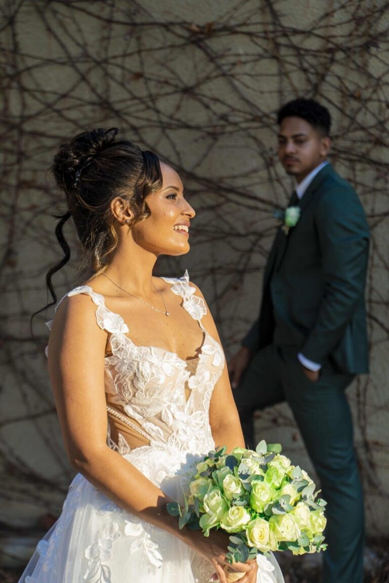Bride holding her bouquet beside her groom