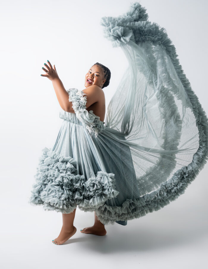 Maternity portrait in a flowing ruffled gown