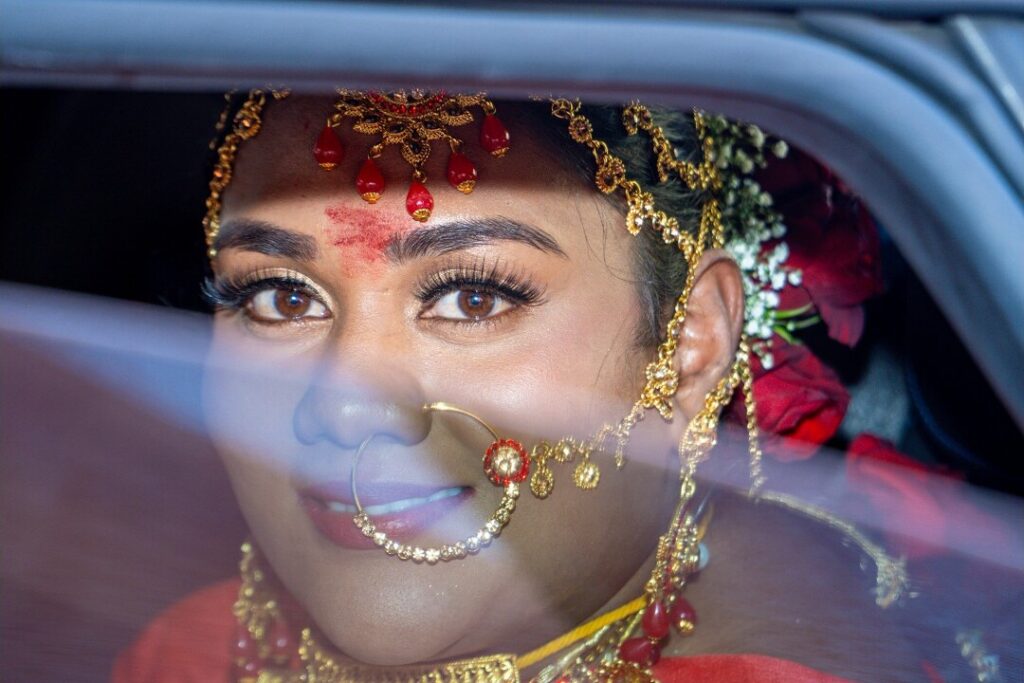 Frame from a wedding film: bride in a car on her way to the ceremony