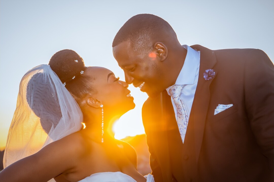 Frame from a wedding film: couple at sunset