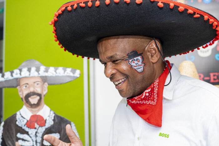 Guest in a sombrero laughing at a themed party