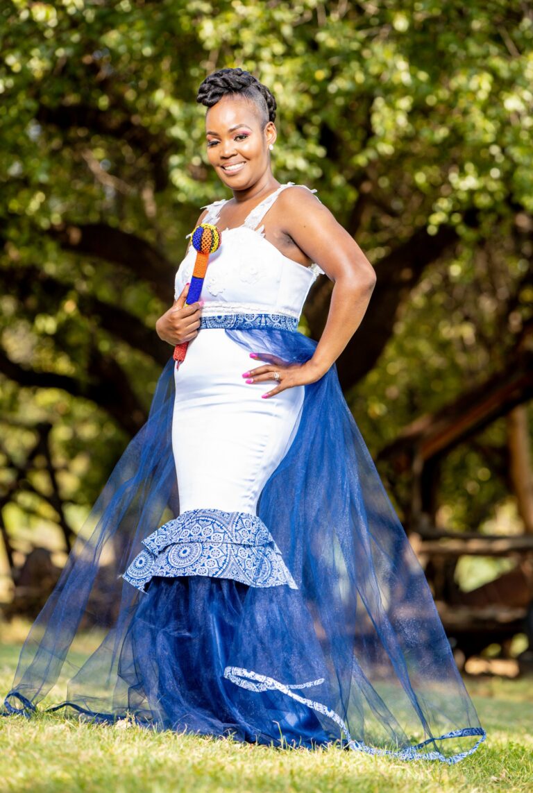 Bride in a white and blue traditional gown with a sheer navy overskirt