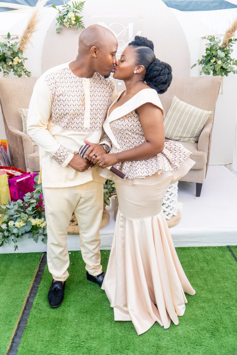 Couple sharing a kiss in front of their decorated stage