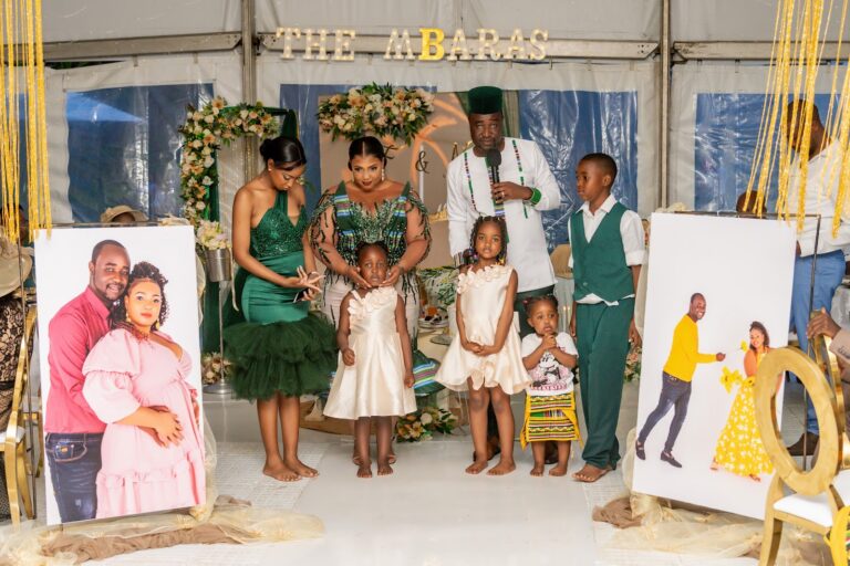 Family portrait in matching traditional attire under a decorated marquee