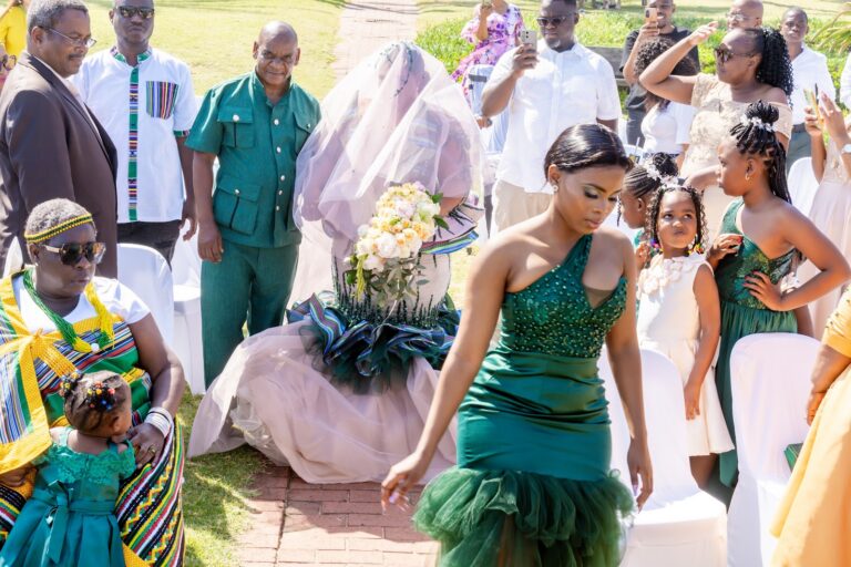 Guests in coordinated outfits celebrating around the bride
