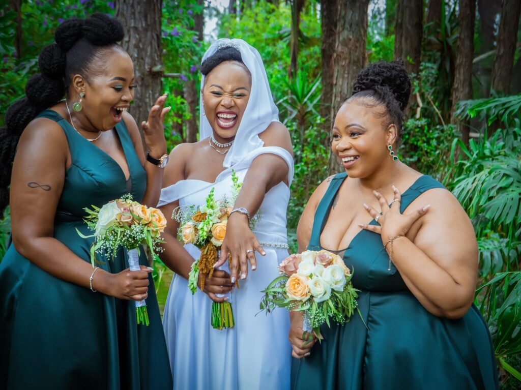 Bride showing her ring to her delighted bridesmaids