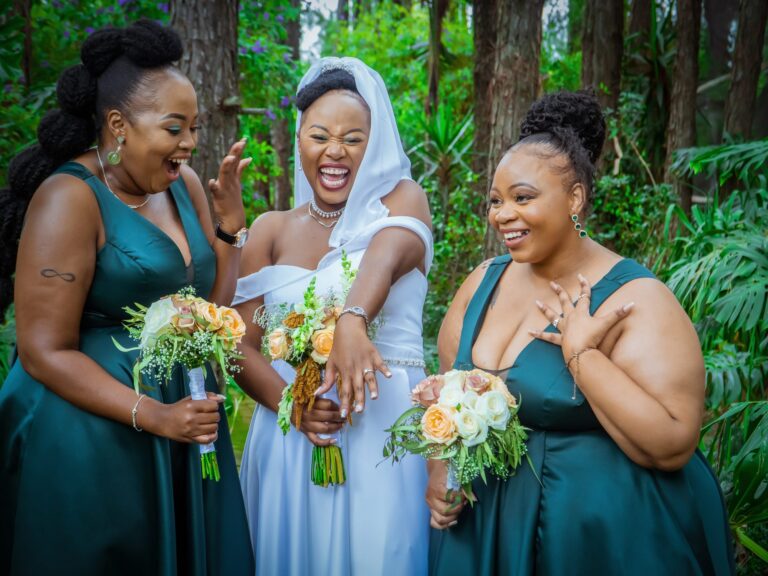 Bride showing her ring to her delighted bridesmaids