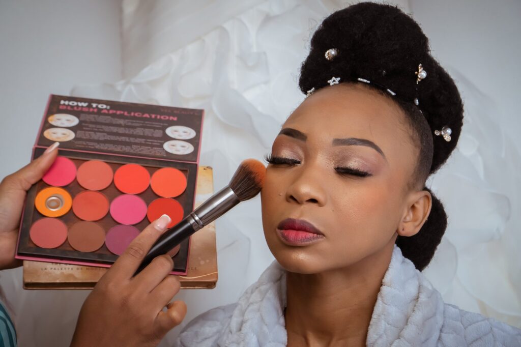 Bride having her makeup applied on the morning of the wedding