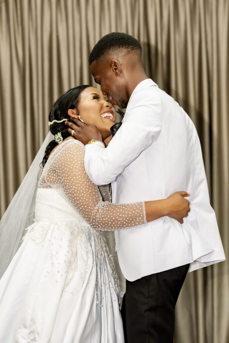 Groom leaning in to kiss his bride