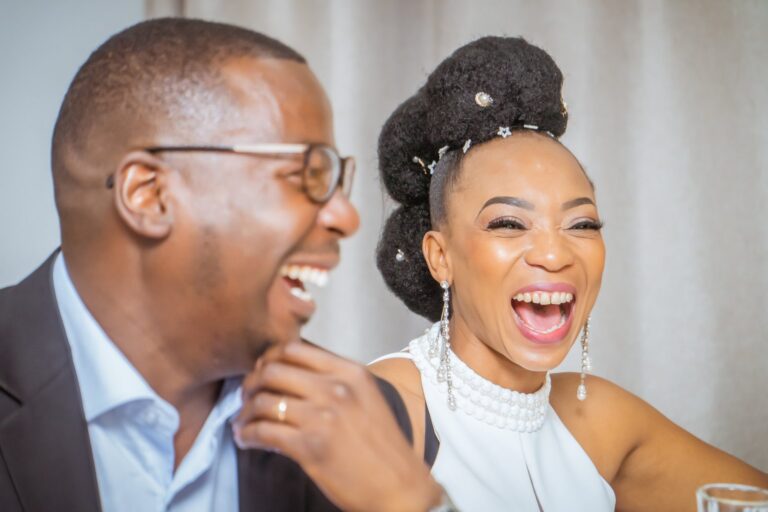 Newlyweds laughing together at the dinner table