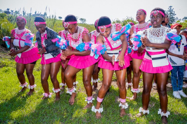 Young women dancing in beaded skirts at a traditional wedding