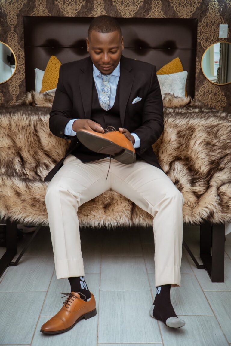 Groom polishing his shoe while getting ready