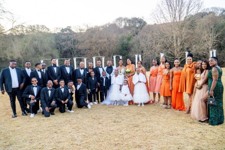 Full wedding party lined up for a group photograph