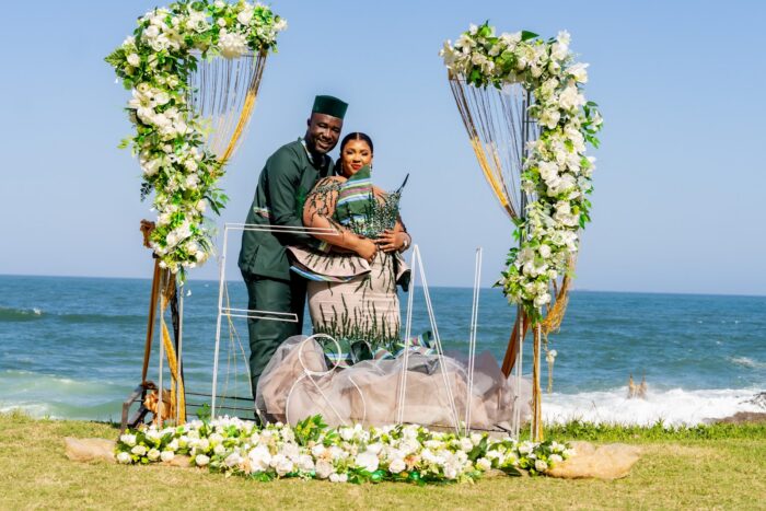 Couple exchanging vows under a floral arch