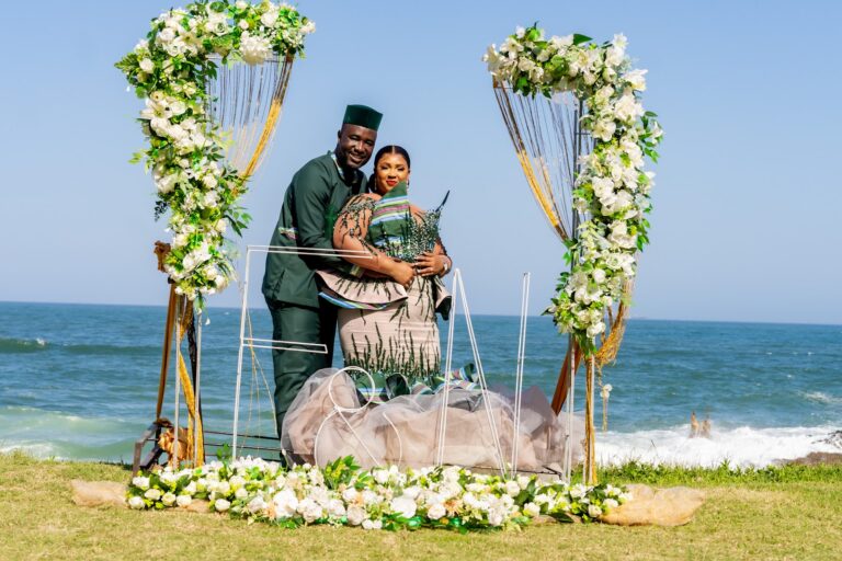 Couple exchanging vows under a floral arch