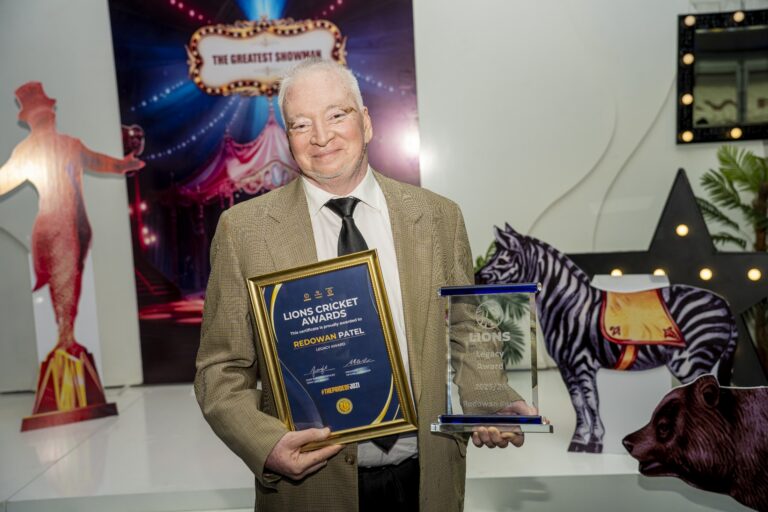 DP World Lions Cricket Awards winner with certificate and trophy on the themed set