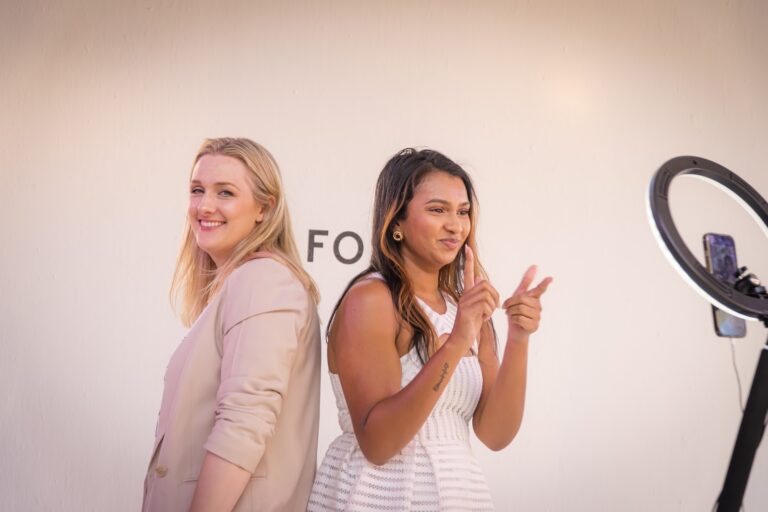 Two guests posing playfully at the ring-light content station at the Fossil brand activation