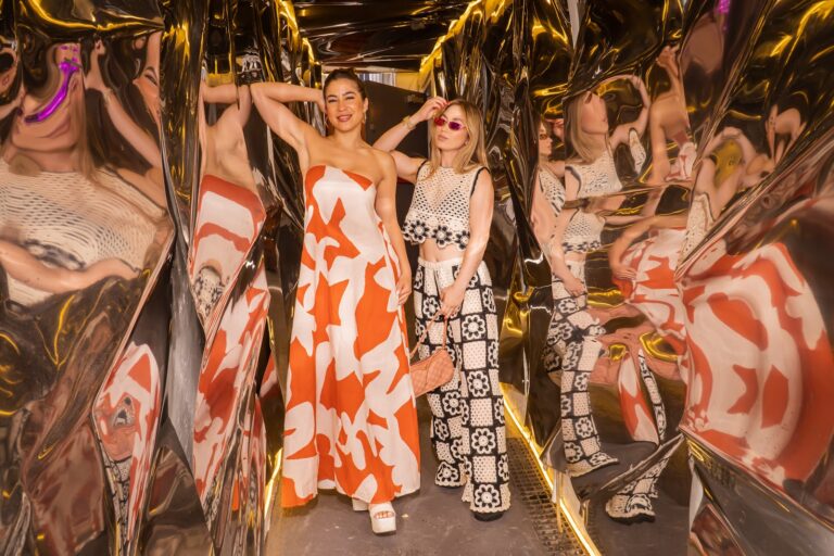 Guests posing inside the gold mirrored installation at the Fossil brand activation