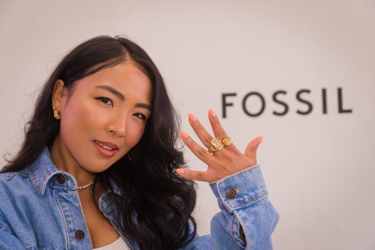 Guest showing off her rings in front of the Fossil logo wall