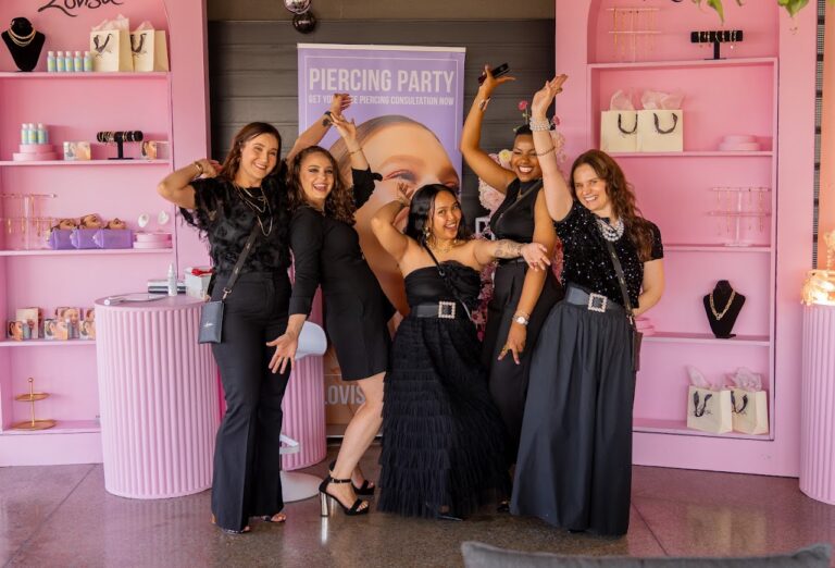 Guests posing at the pink piercing-party display at the Lovisa brand activation
