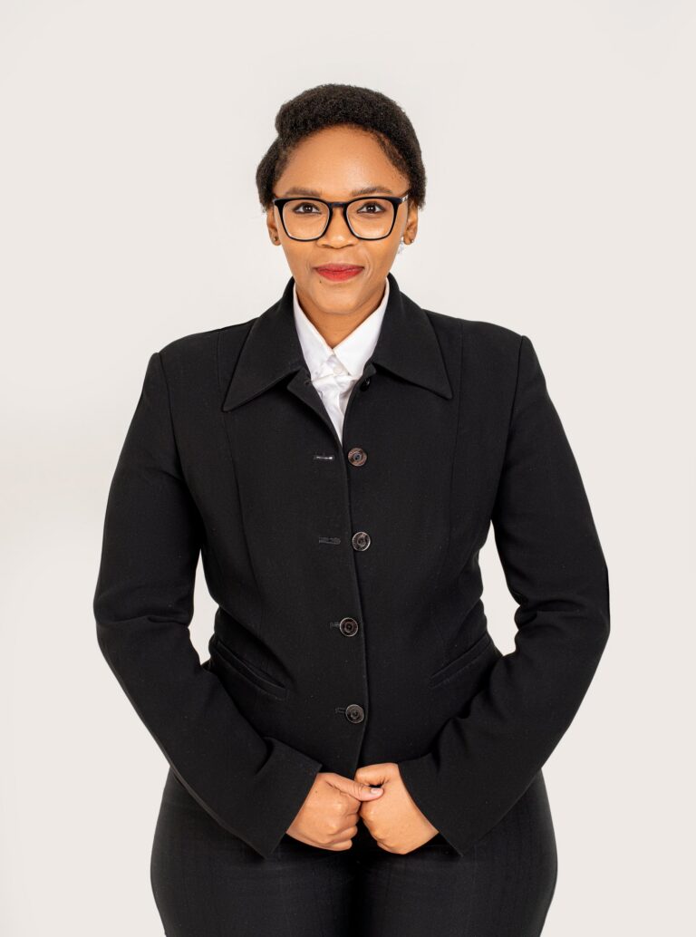 Professional headshot, black jacket and glasses on a white backdrop, by Studio24.7
