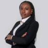 Professional headshot, black blazer, arms crossed, on a light grey backdrop, by Studio24.7