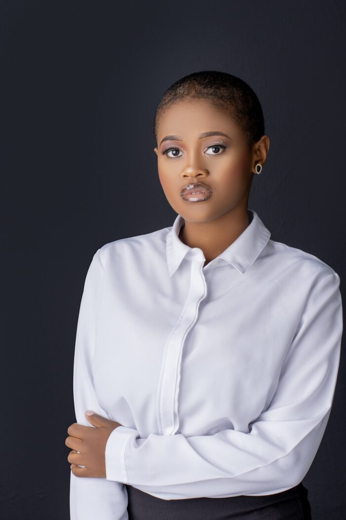 Professional headshot, white shirt on a dark backdrop, by Studio24.7