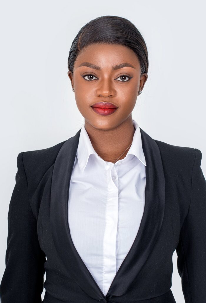 Professional headshot, black suit and white shirt on a light backdrop, by Studio24.7